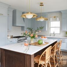 White and Blue Kitchen With Subway Tile Backsplash and Brass Light Fixtures