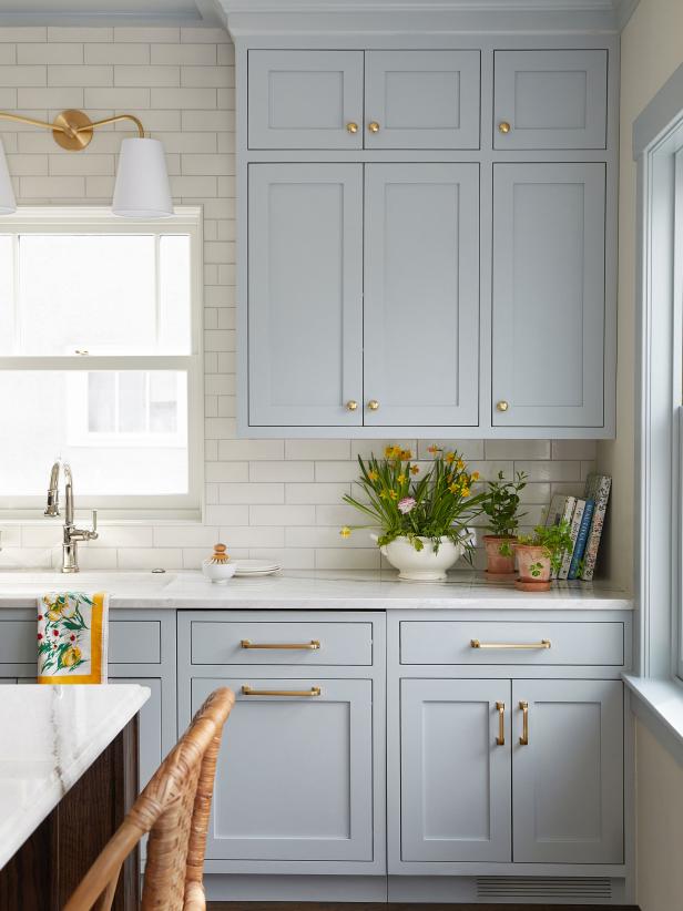 Transitional White Kitchen With Light Blue Cabinets and Brass Accents ...