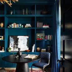 Teal Built-In Bookcase and Round Black Dining Table