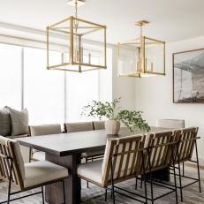 Contemporary Dining Room With Gold Light Fixtures