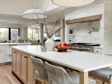 Contemporary White and Oak Kitchen With Woven Gray Counter Stools