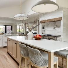 Contemporary White and Oak Kitchen With Woven Gray Counter Stools