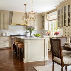 Marble Island With Leather Counter Stools In Cottage Kitchen