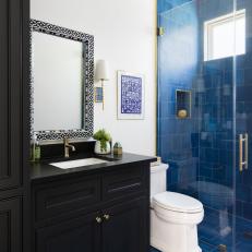 Black and White Bathroom With Blue Tiled Shower