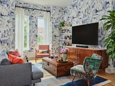 Apartment living room with blue and white brushstroke-style wallpaper. 