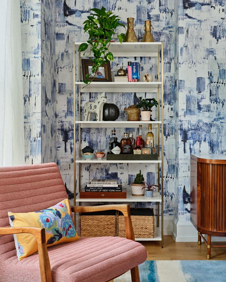 Six-shelf bookcase with books, photos, and knick-knacks. 