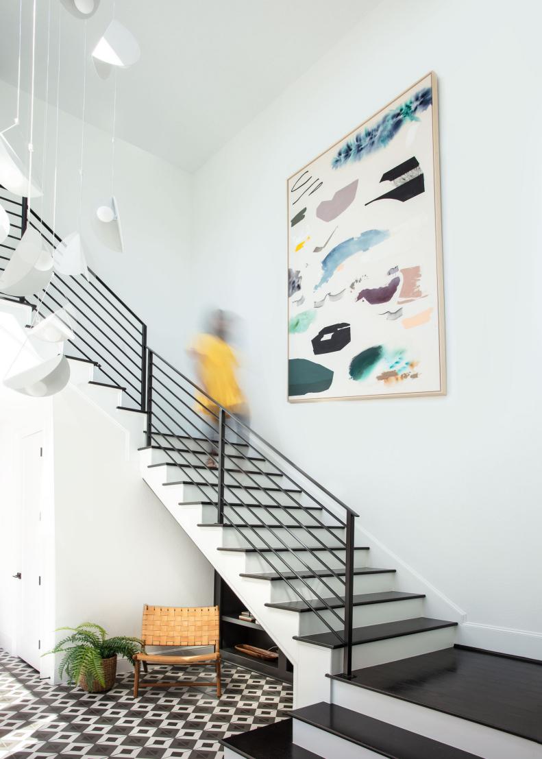 Foyer With Stairwell and Large Framed Abstract Painting
