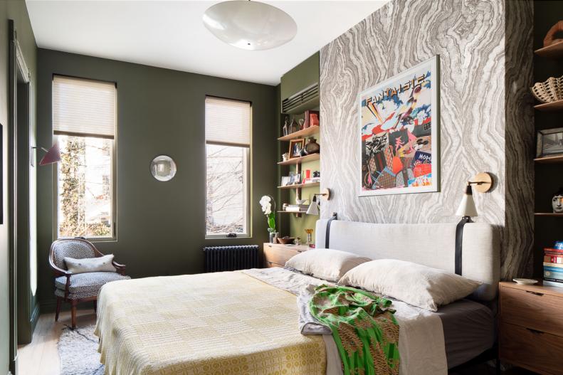Bedroom With Green Walls and Built-in Shelves Flanking Bed