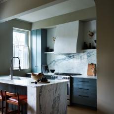Townhome Kitchen With Blue Cabinets and Island Sink