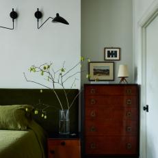 Moody Midcentury Bedroom with Rich, Green Bed Spread and Contrasting Dresser