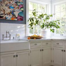 Bright, White Kitchen With Colorful Photograph