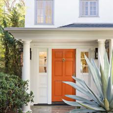 White Front Porch With Orange Door