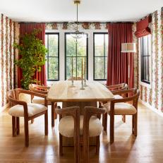 Dining Room With Red Floral Wallpaper, Red Curtains, and Six-Person Table
