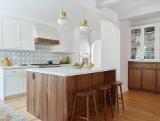 Kitchen With Beadboard Island and Two Gold Pendant Lights