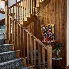Wood Paneled Stairwell With Runner