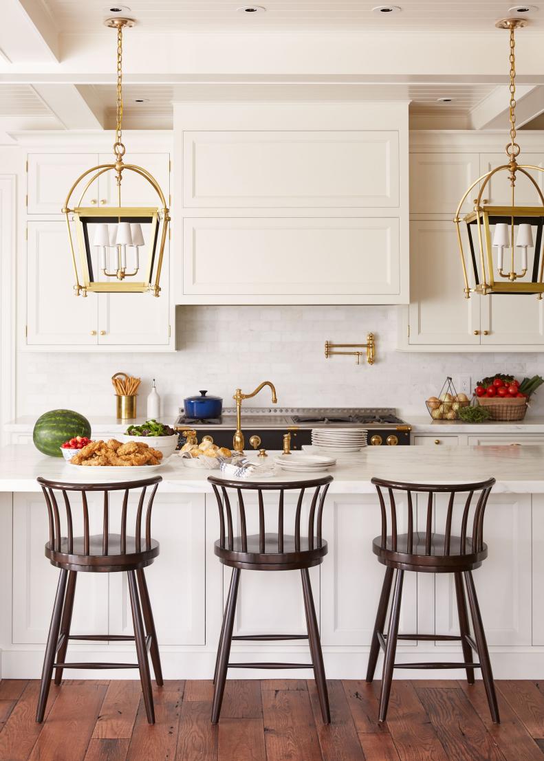 Three Barstools at Marble-Topped White Kitchen Island