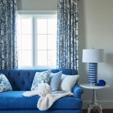Blue Furniture and Accents Liven Up Neutral Transitional Nursery Sitting Area