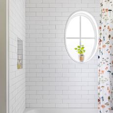 Shower With White Subway Tile and Oval Window