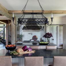 Rustic Kitchen Island With Black Countertop and Seating for Six