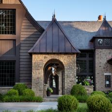 Neutral Transitional Home With Arched Stone Entryway