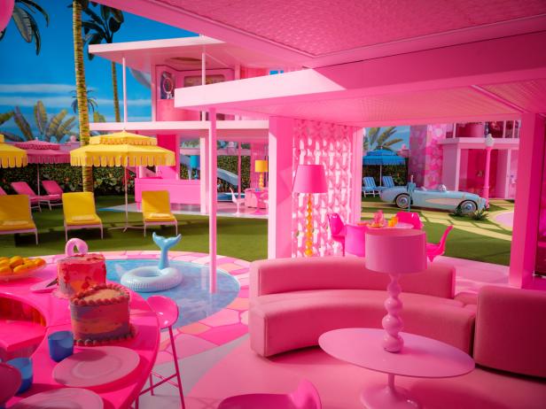 Pink room with curved pink sofa, pink ceiling, and pool.