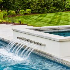 Hot Tub With Water Fountain In Modern Backyard