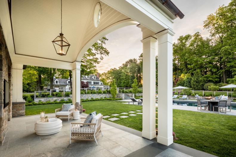 modern pool house with outdoor TV and chairs