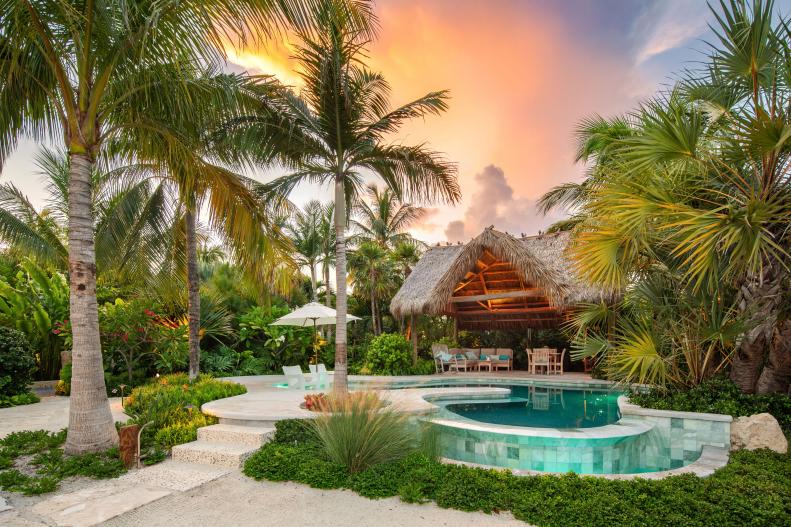 lagoon-shaped pool set next to a chickee hut in Florida keys