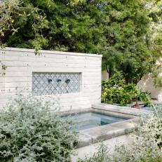 Spanish-Inspired Yard With White Brick Fountain