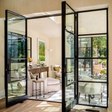 Sunroom With Checkered Floors and Black French Doors