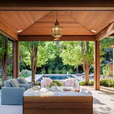 Wood Covered Patio By Pool In Backyard
