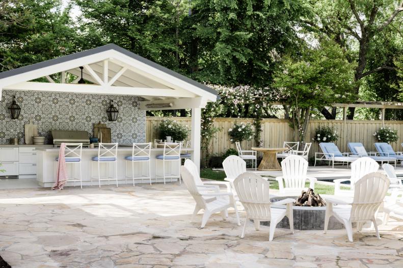 fire pit with outdoor kitchen in the background