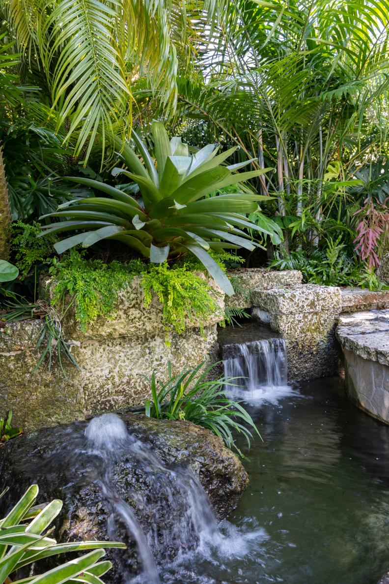 koi pond with waterfall and rock fountain
