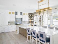 Kitchen Island With White Marble Waterfall Counter and Barstools