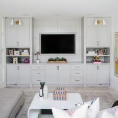 White Contemporary Living Room With TV Embedded in Wall With Built-In Cabinets