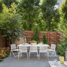 Backyard With White Dining Table and Chairs