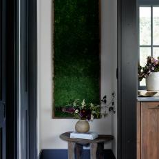 Tall Green Framed Plant Wall in White Transitional Hallway