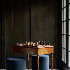 Chess Table in Dark Wood-Paneled Room