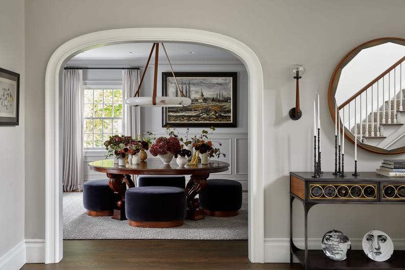 Arched Doorway Leads to Dining Room With Round Table and Stools