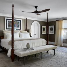 Neutral Transitional Bedroom With Arched Doorways