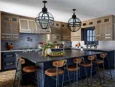 Blue Kitchen Island Lined With Wood-Backed Barstools