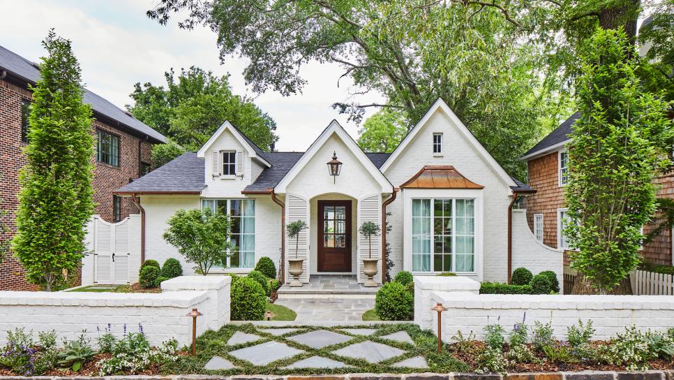 Front of White Traditional Gabled Home With Landscaping and Hardscaping