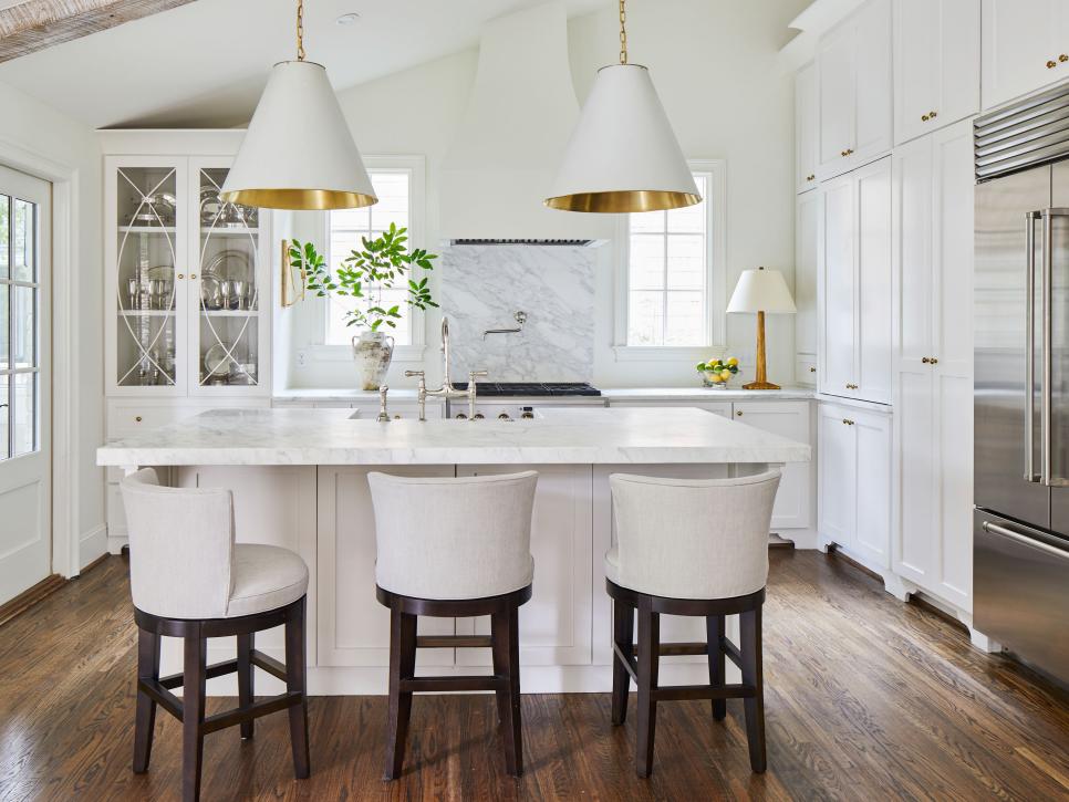 Gold-and-White Pendant Lights Above Island in Eat-In Kitchen