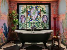 Black-and-White Clawfoot Tub in Front of Stained-Glass Window
