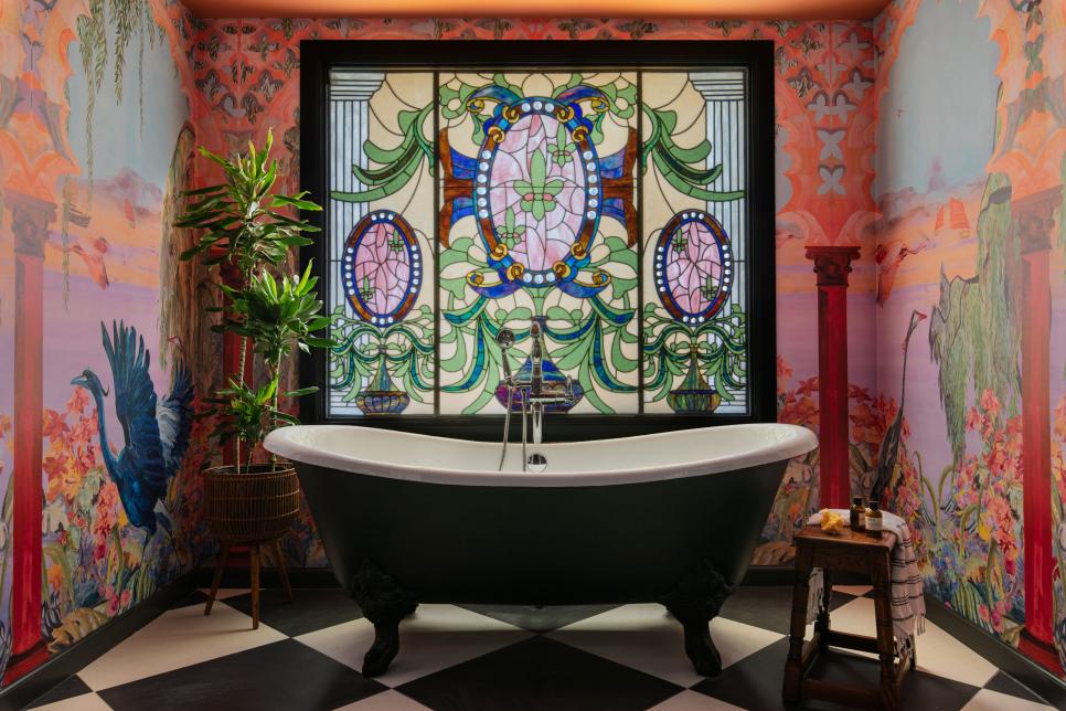 Black-and-White Clawfoot Tub in Front of Stained-Glass Window