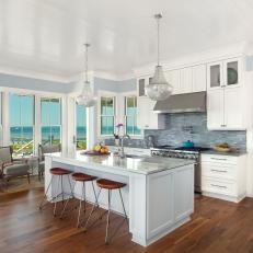 Seaside Kitchen With White Cabinets and Blue Tile Backsplash 