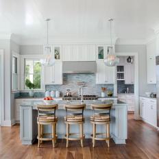 Gray and White Kitchen with Large Island and Stainless Steel Appliances 
