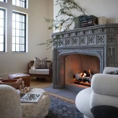 Living Room With Gray Stone Fireplace and Multi-Pane Windows