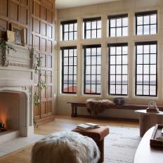 Living Room With Wood Panel Walls and White Fireplace