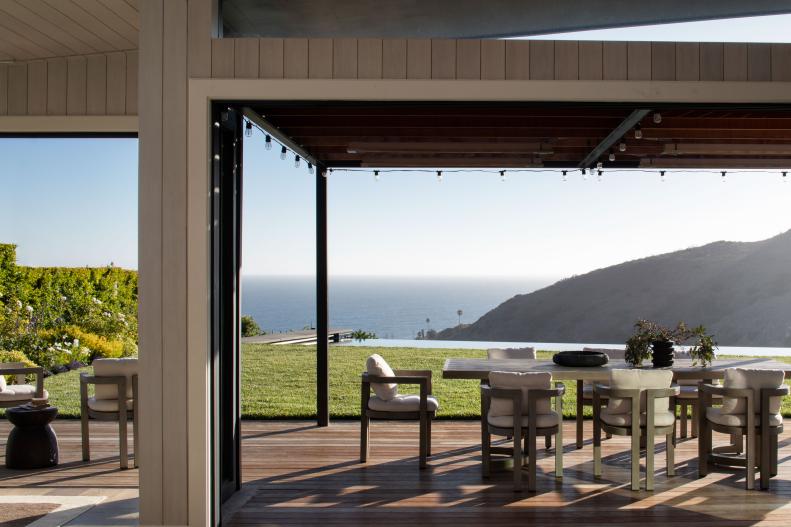 Modern Oceanfront Dining Space With Wall of Windows